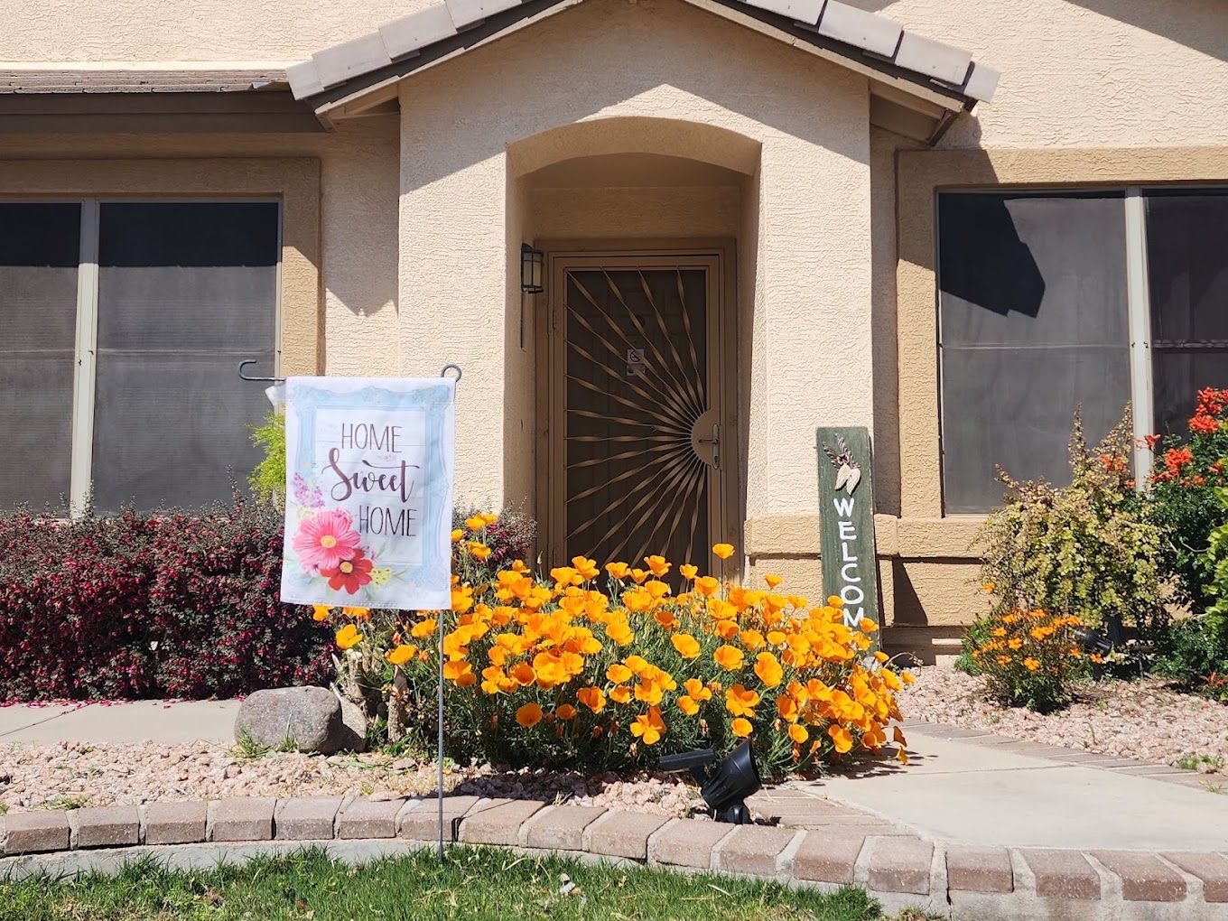 Front entrance of a home with colorful flowers
