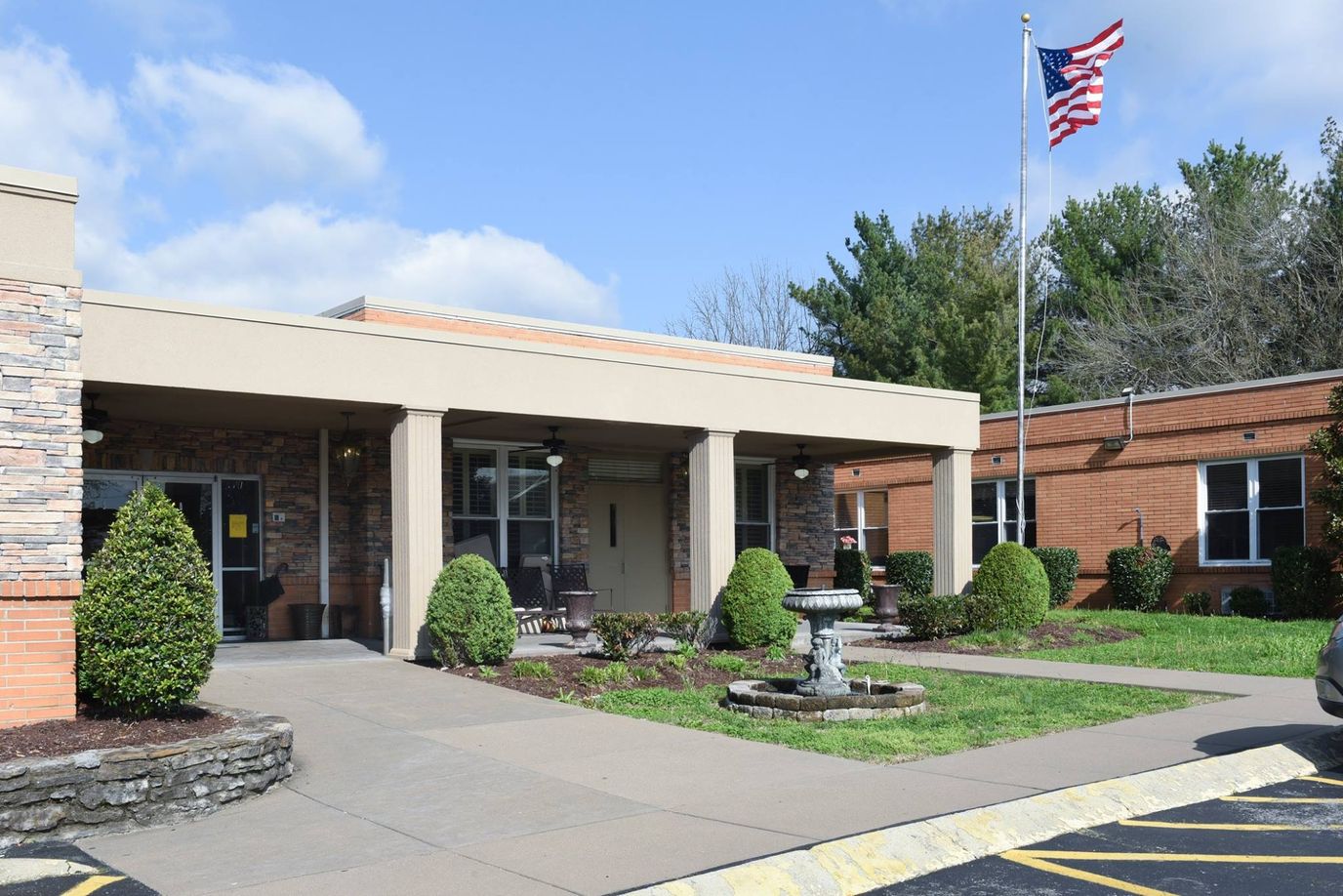 Front entrance of a senior living facility with landscaping