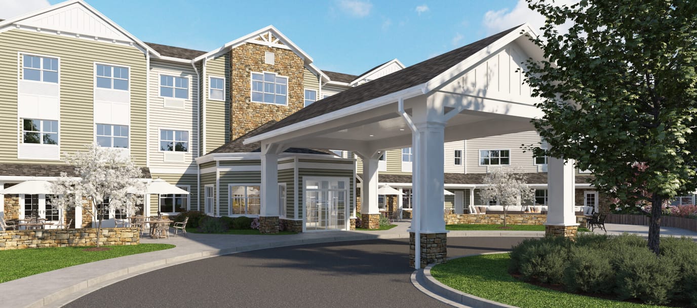 Entrance of a senior living facility with outdoor seating