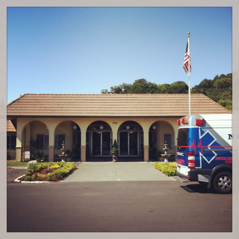 Front view of Novato Healthcare Center with an ambulance parked outside