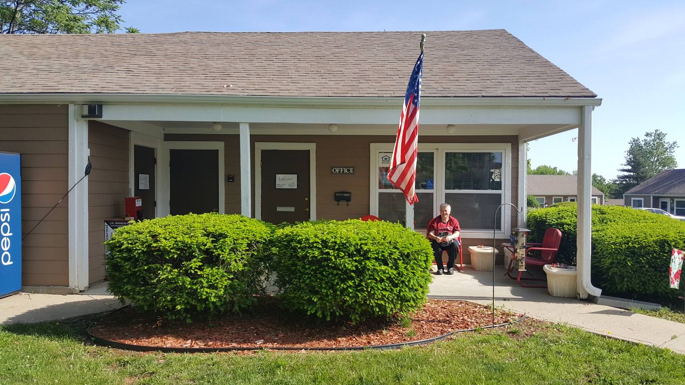 Entrance of Parkview Gardens Apartments with a resident outside