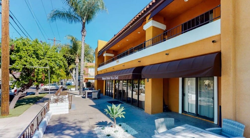 Outdoor view of the facility building with palm trees
