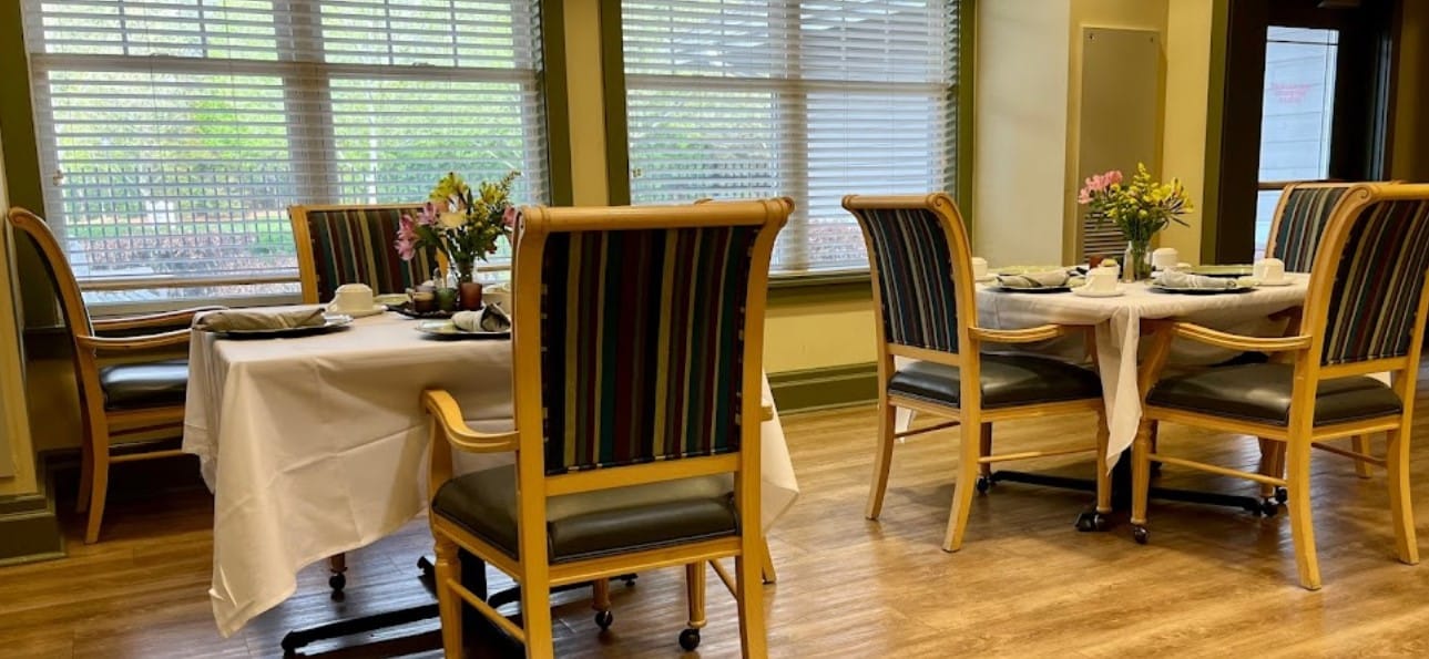 Dining area set for a meal with floral centerpieces
