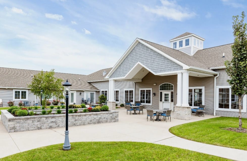 Exterior view of a senior living facility with landscaped garden