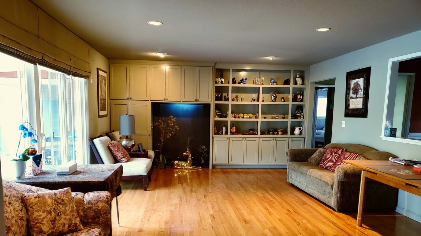 Bright common area with seating and decorative shelves