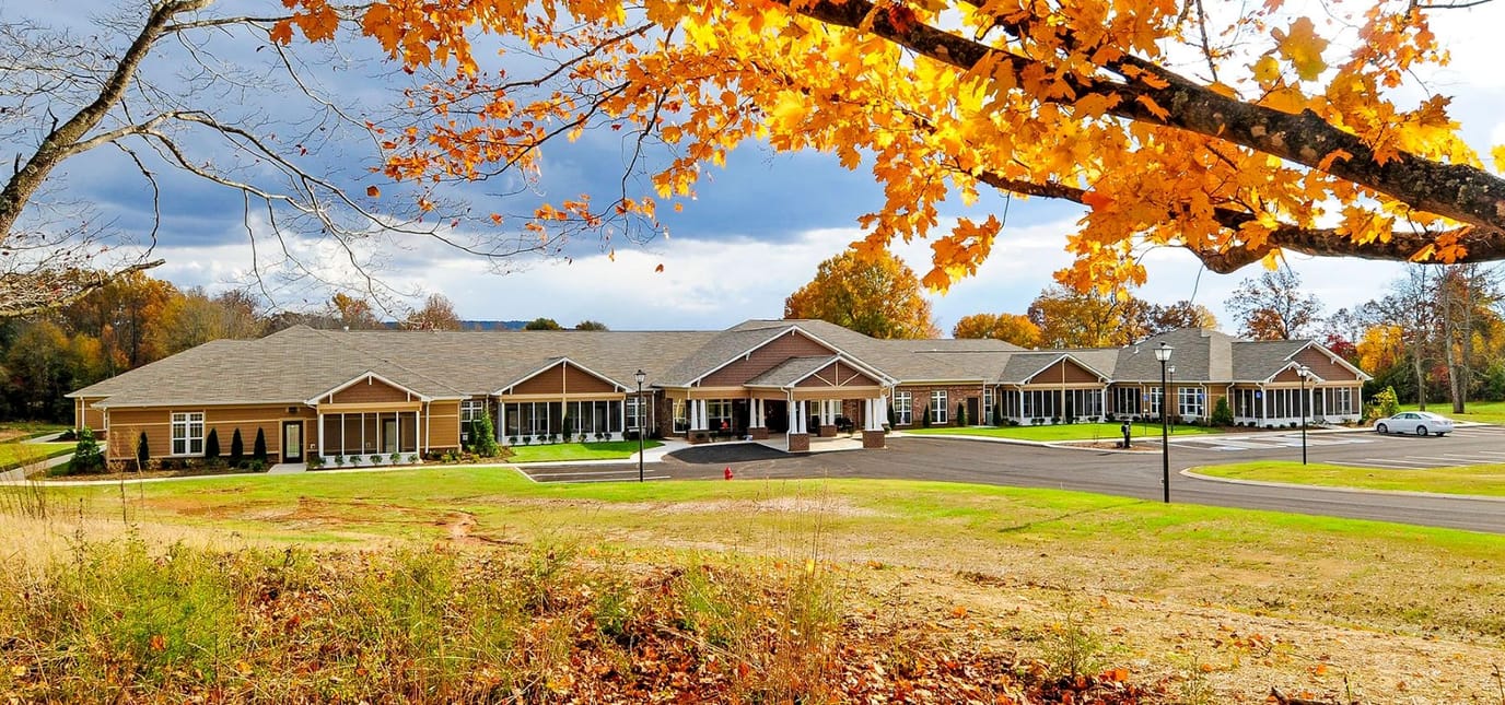 Exterior view of Webb House Retirement Center with autumn foliage