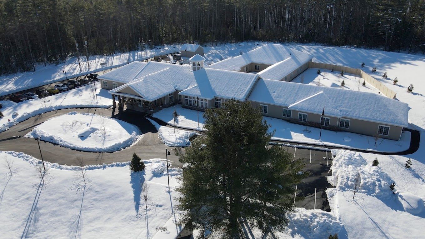 Aerial view of Woodlands Memory Care facility in winter.