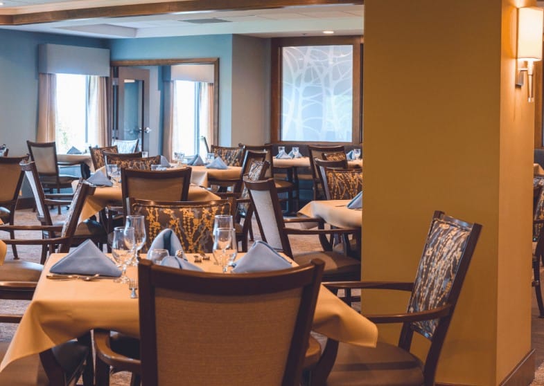 Dining room with elegantly set tables and chairs