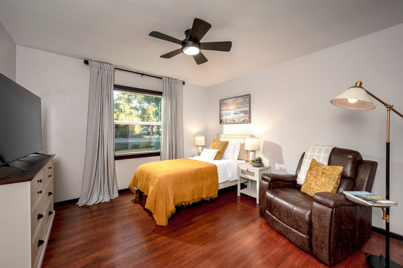Cozy private bedroom with a yellow blanket.