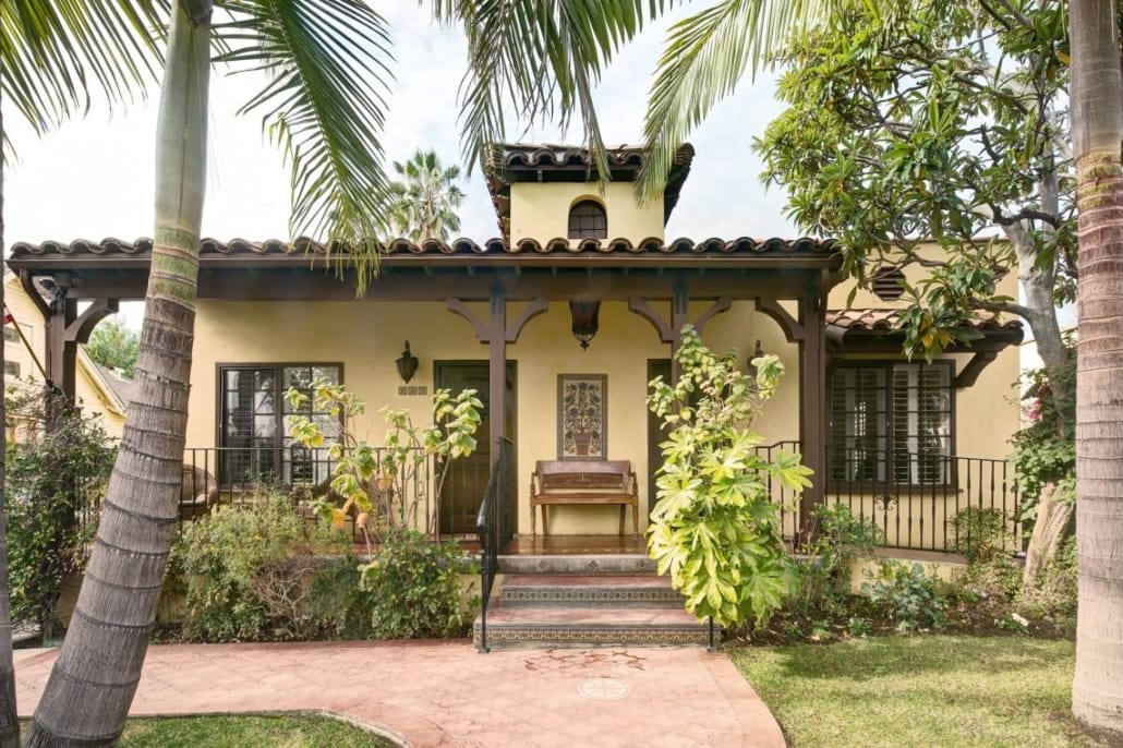 Exterior view of a senior living facility with palm trees