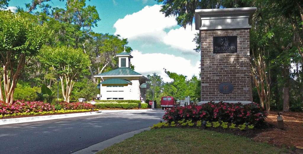 Outdoor view of entrance with signage and landscaping