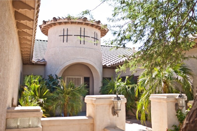 Outdoor view of a senior living facility with palm trees