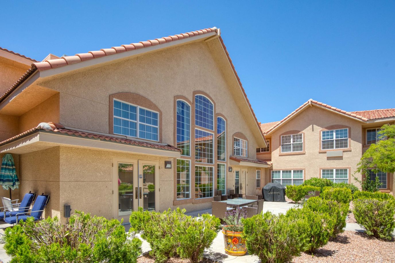 Exterior view of a senior living facility with landscaped garden