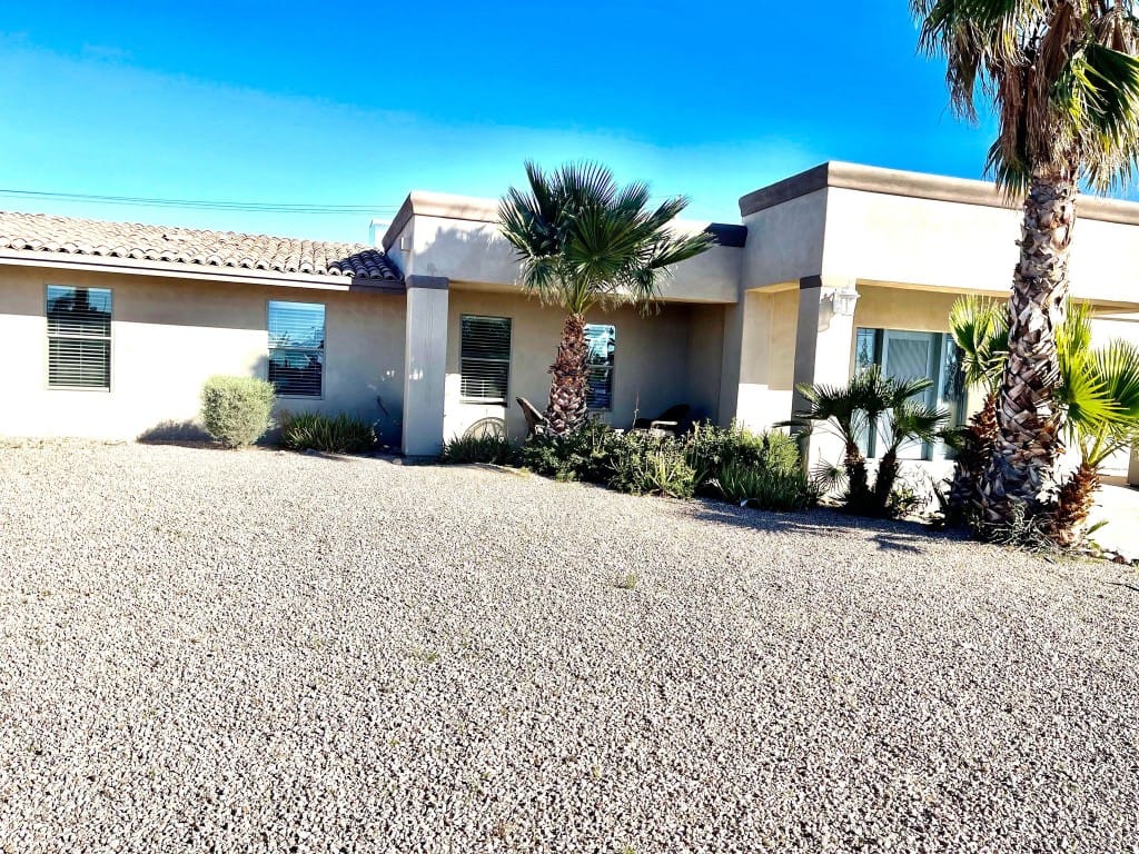 Exterior view of the Rainbow House facility with palm trees