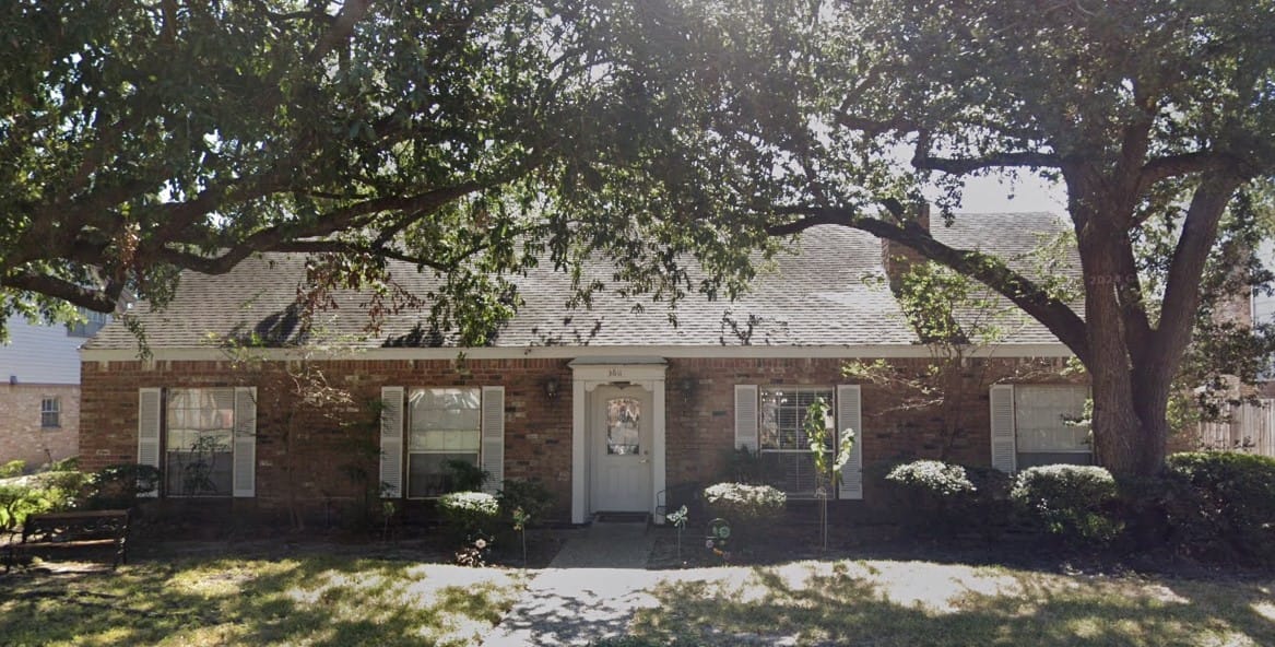 Exterior view of Avid Care Cottages with landscaped yard