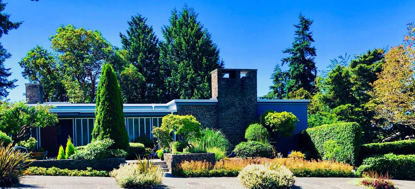 Exterior view of Carlton Park Adult Family Home surrounded by gardens