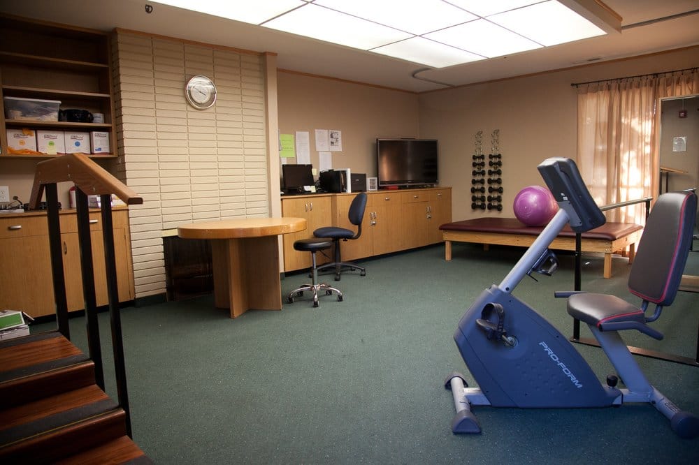 Activity room with exercise equipment and seating area