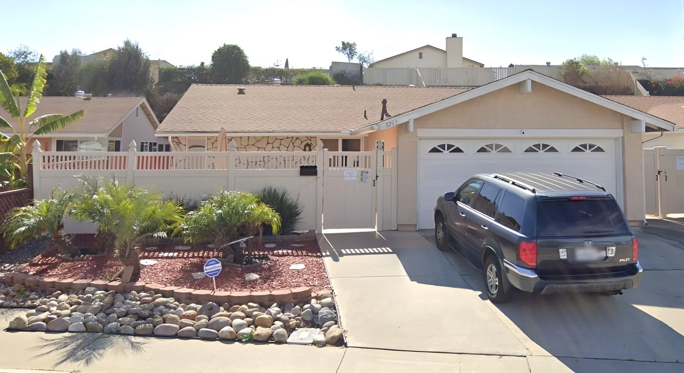 Exterior view of a residential facility with parking area