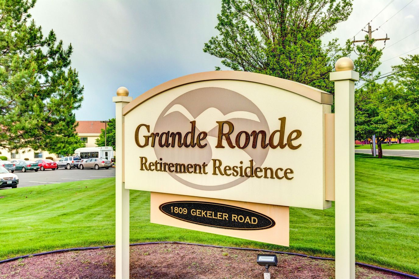 Sign for Grande Ronde Retirement Residence in a landscaped area