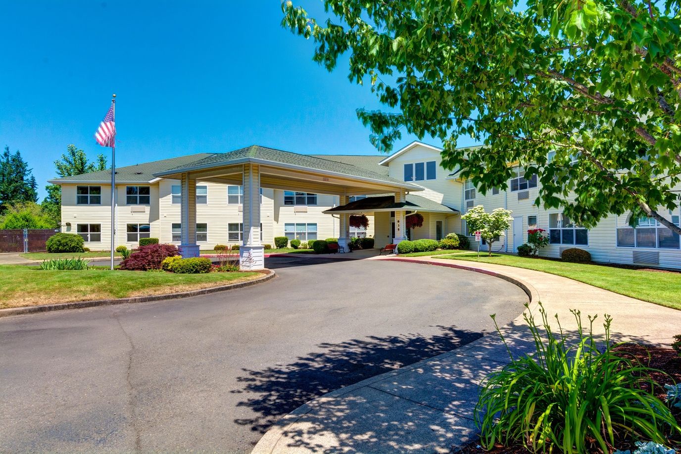 Entrance of a senior living facility with landscaped grounds