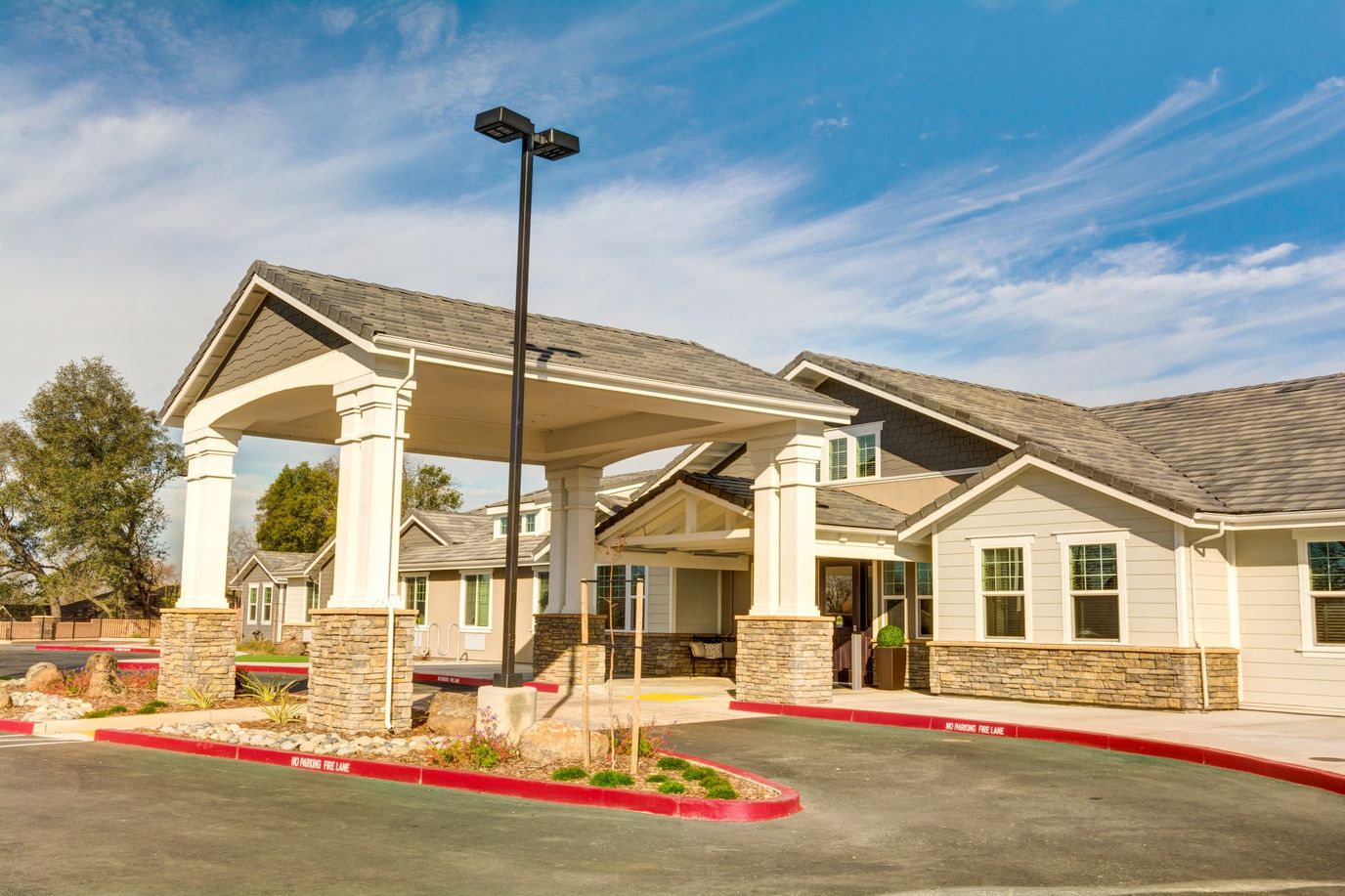 Exterior view of assisted living facility with covered entrance