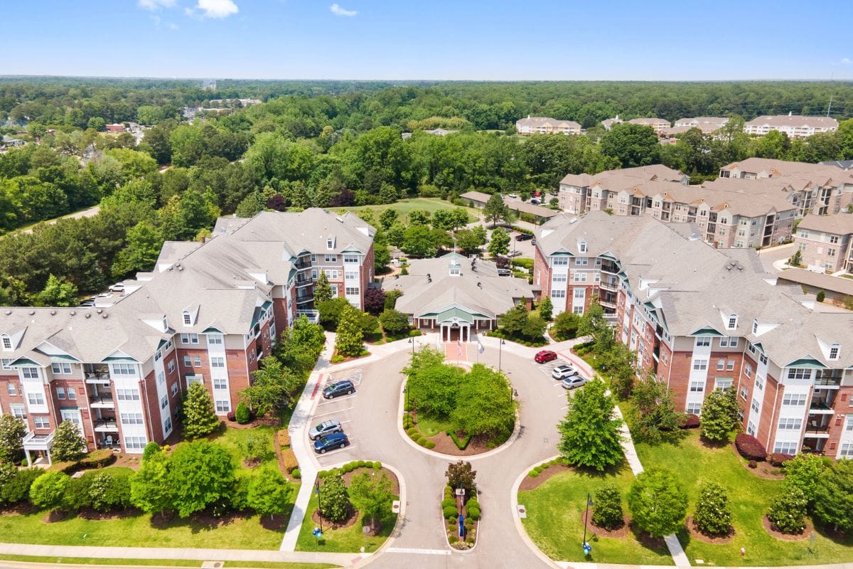 Aerial view of a senior living facility with gardens and pathways