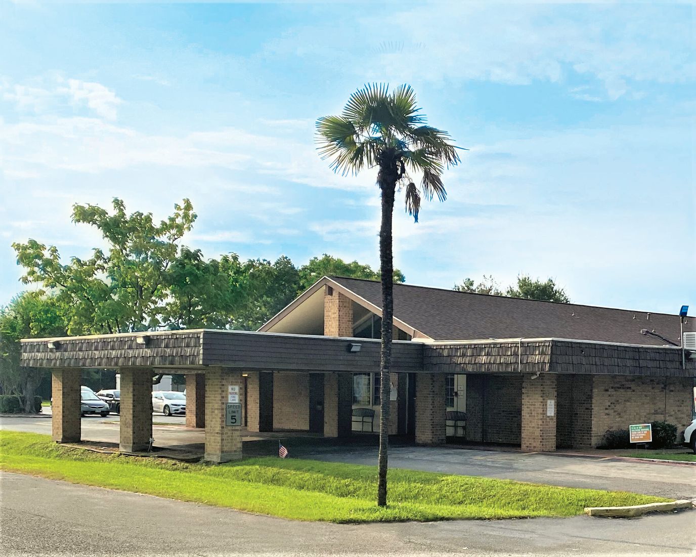 Exterior view of the facility with palm tree