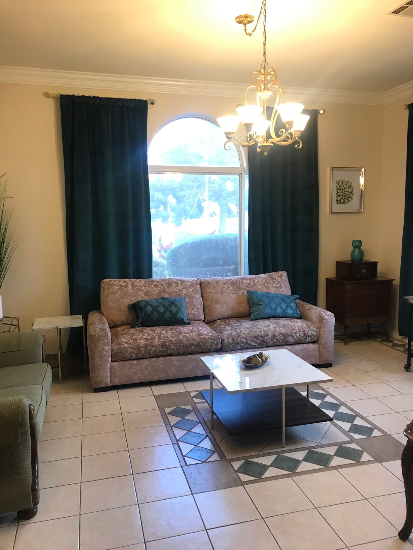 A cozy common area with a sofa and decorative curtains