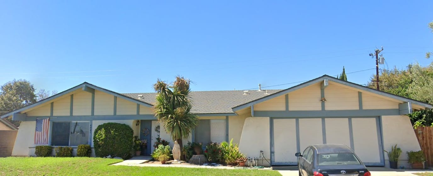 Exterior view of Genesis Manor III with landscaping