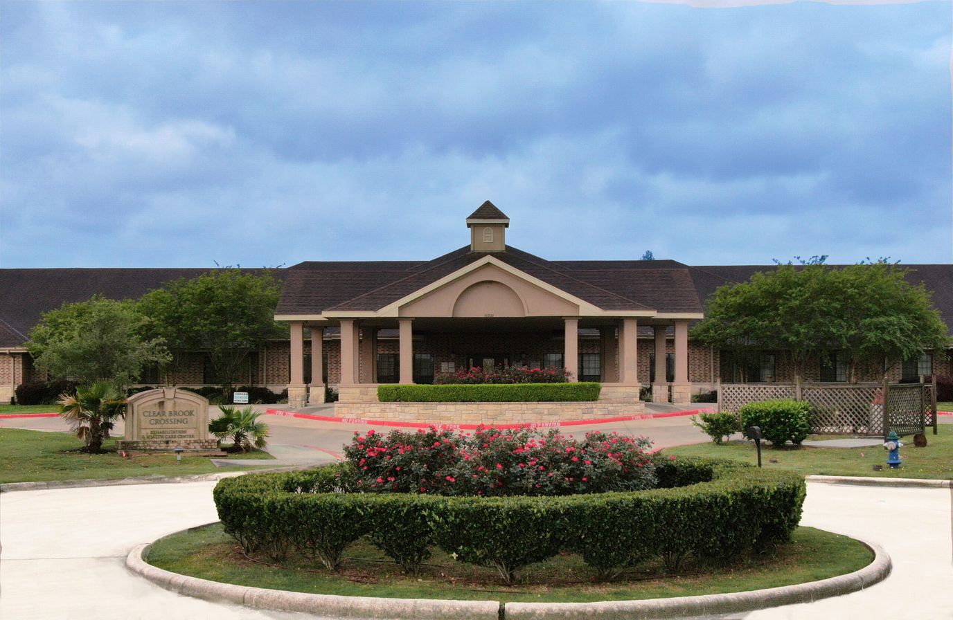 Exterior view of a nursing facility entrance and gardens