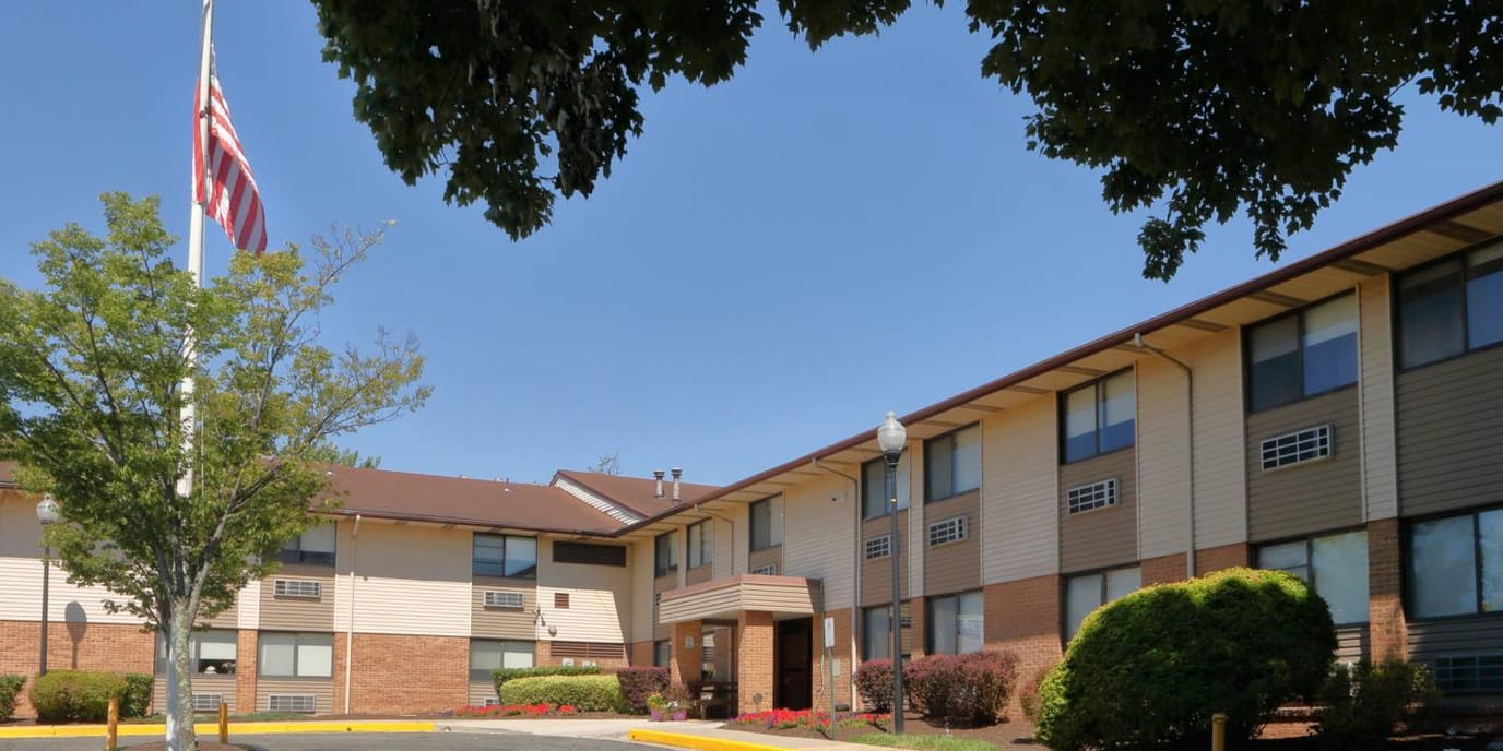 Exterior view of assisted living facility with American flag.