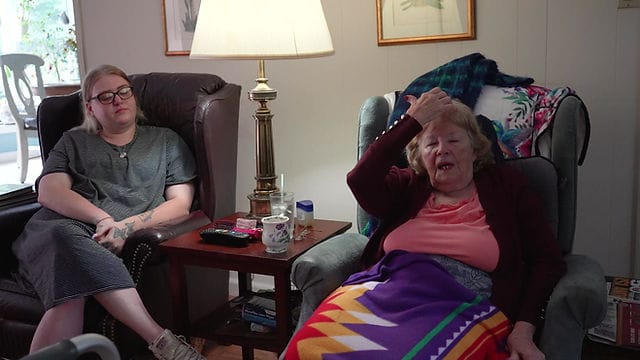 Residents chatting and relaxing in a cozy living area