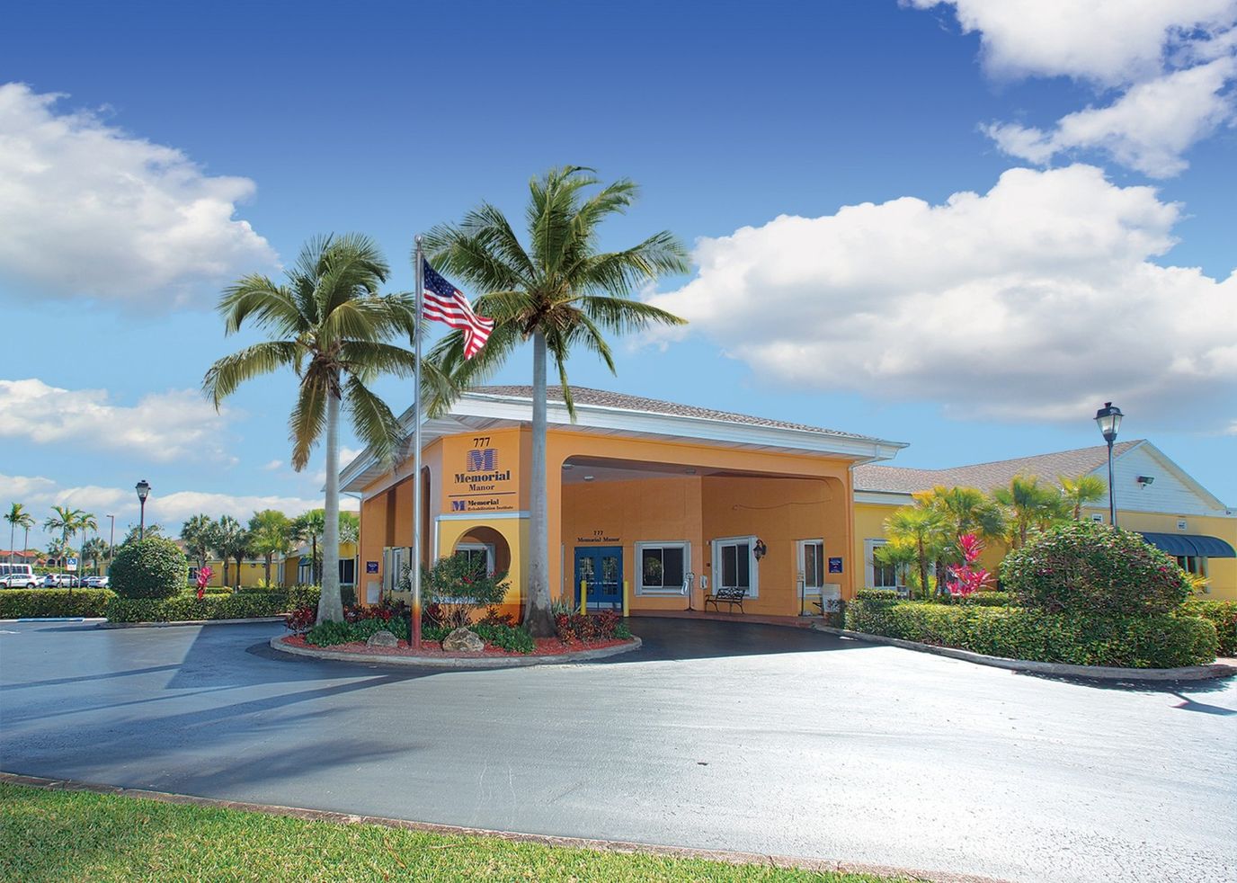 Front entrance of Memorial Manor with palm trees