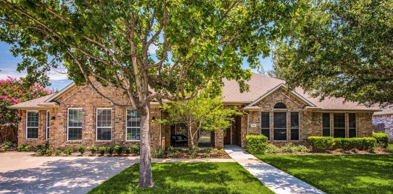 Exterior view of Hillside Assisted Living with lush landscaping