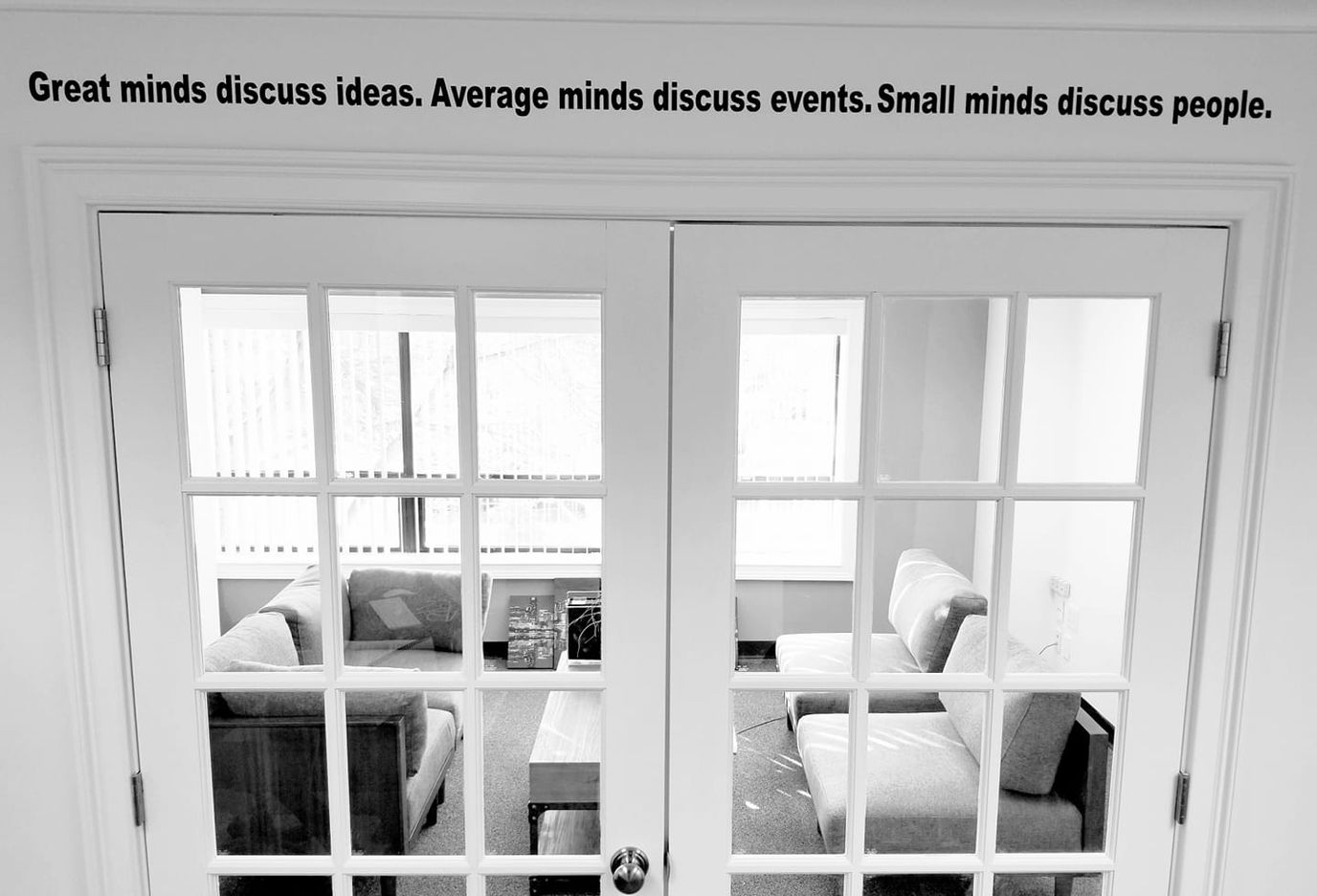 Interior view of a seating area with a quote on the wall