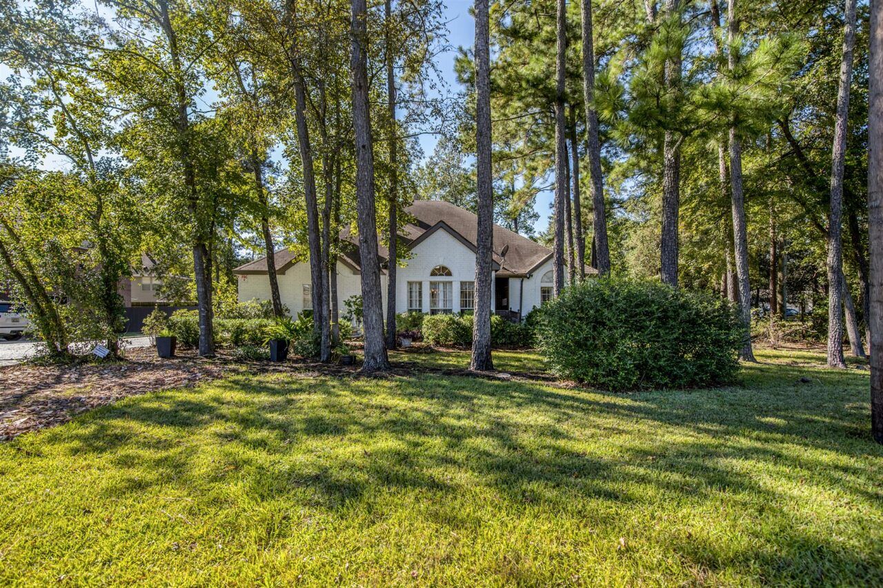 Exterior view of Acorn Manor surrounded by trees.