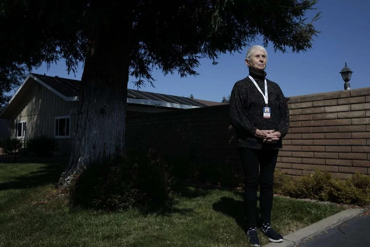 A resident standing outside near the facility building
