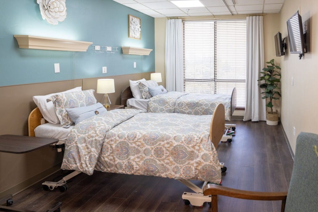 Private resident room with two beds and natural light.