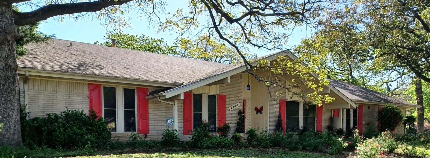 Exterior view of a senior care home with garden