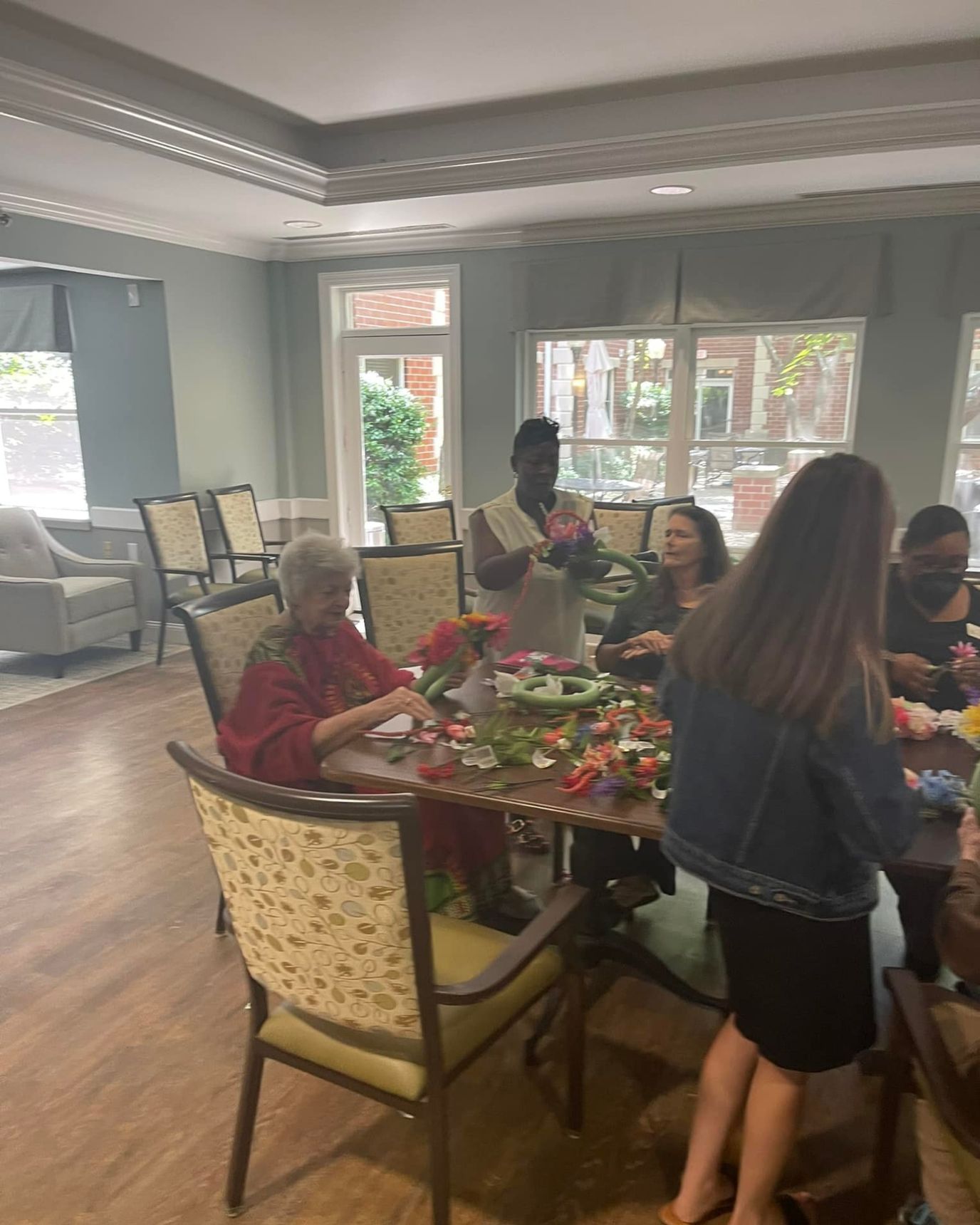 Residents and staff engaging in a flower arranging activity