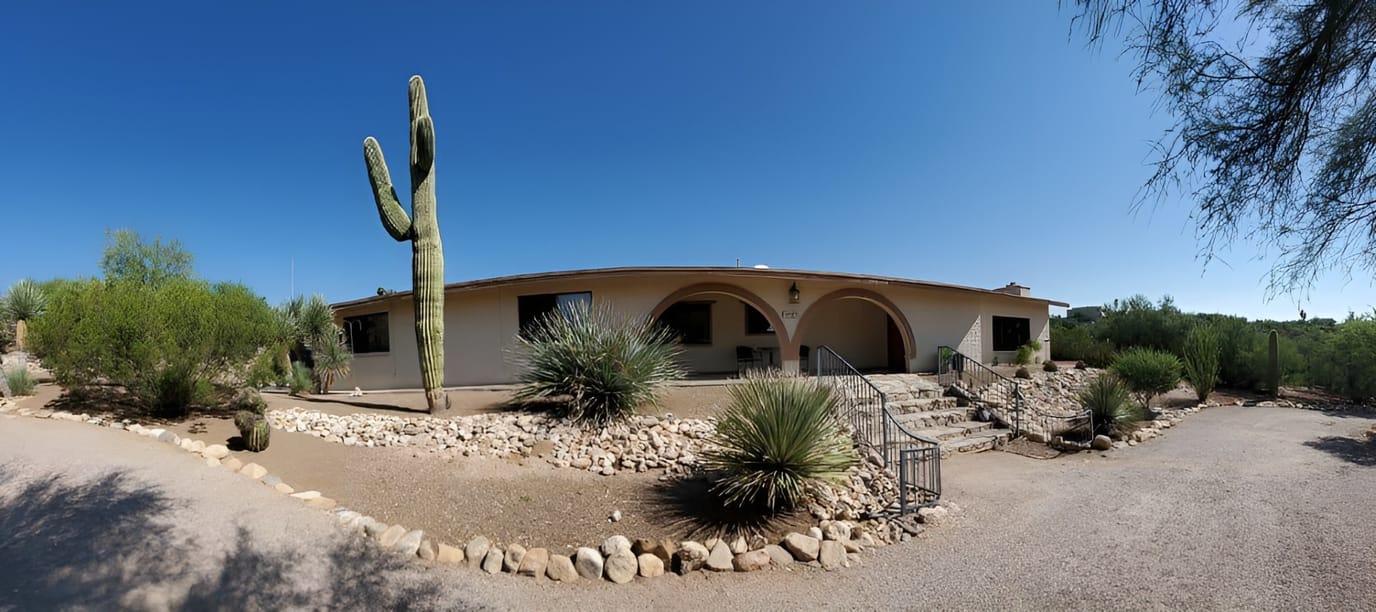 Exterior view of a senior care facility surrounded by desert landscaping
