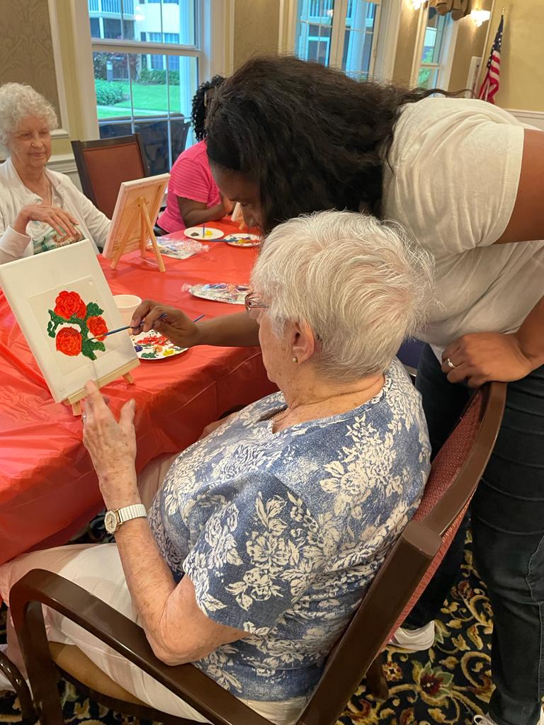 Residents participating in a painting activity inside the facility