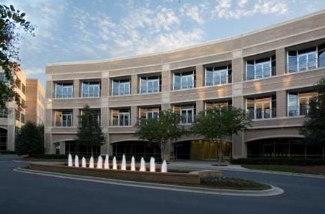 Exterior view of a senior care facility with landscaping.