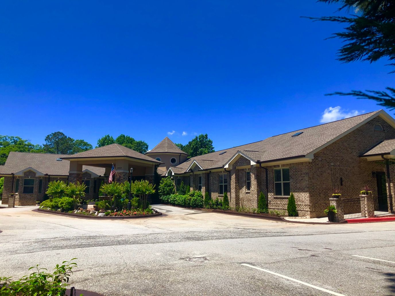 Exterior view of a senior living facility with landscaped entrance