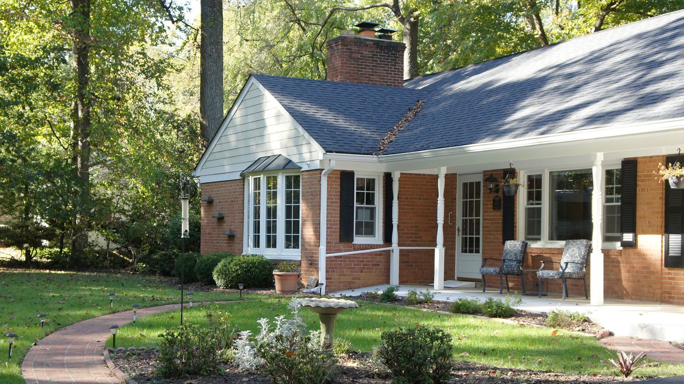 Exterior view of a senior living facility with landscaped garden