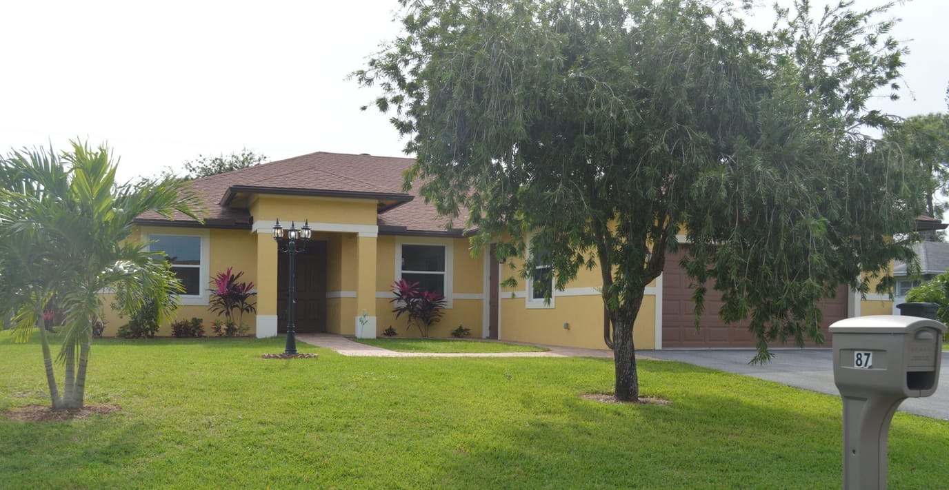 Exterior view of a residential facility surrounded by greenery