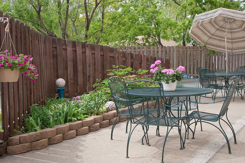A peaceful outdoor seating area with flowers