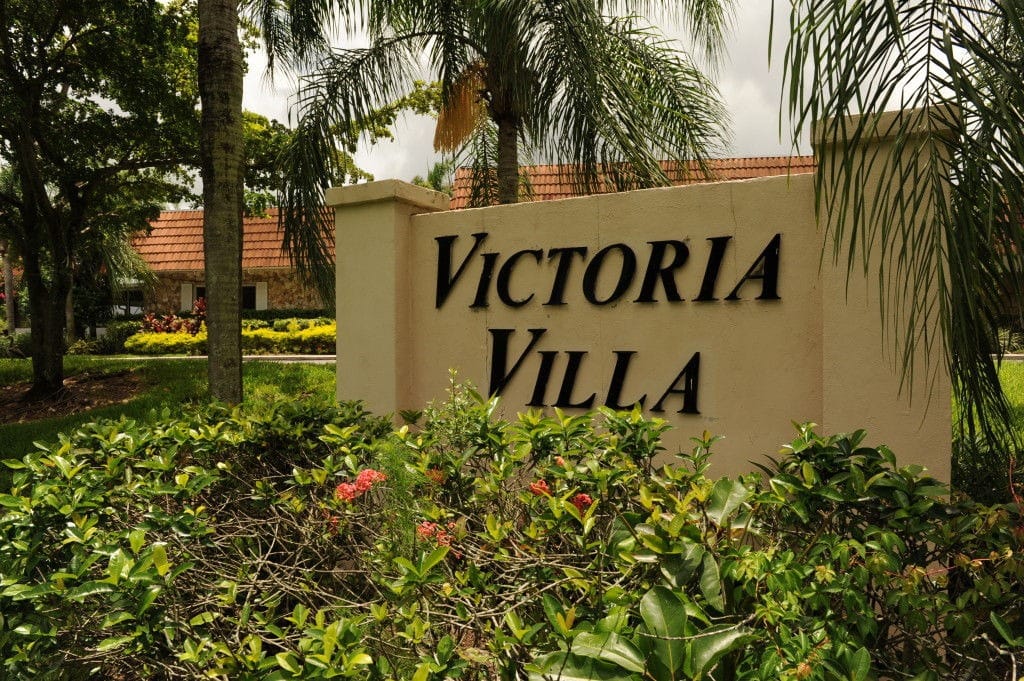 Exterior of Victoria Villa Assisted Living sign amidst greenery