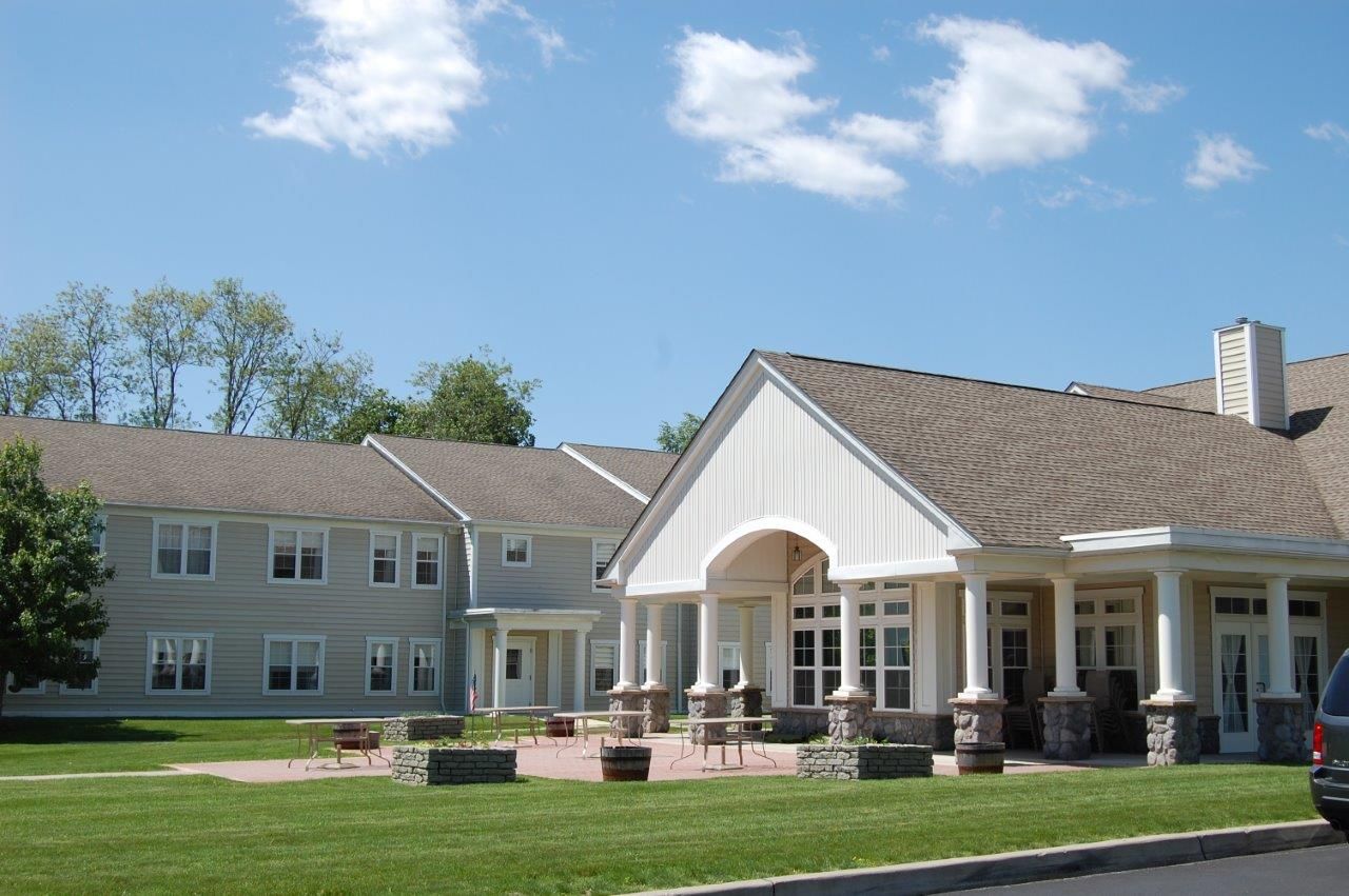 Facade of an assisted living residence with outdoor seating