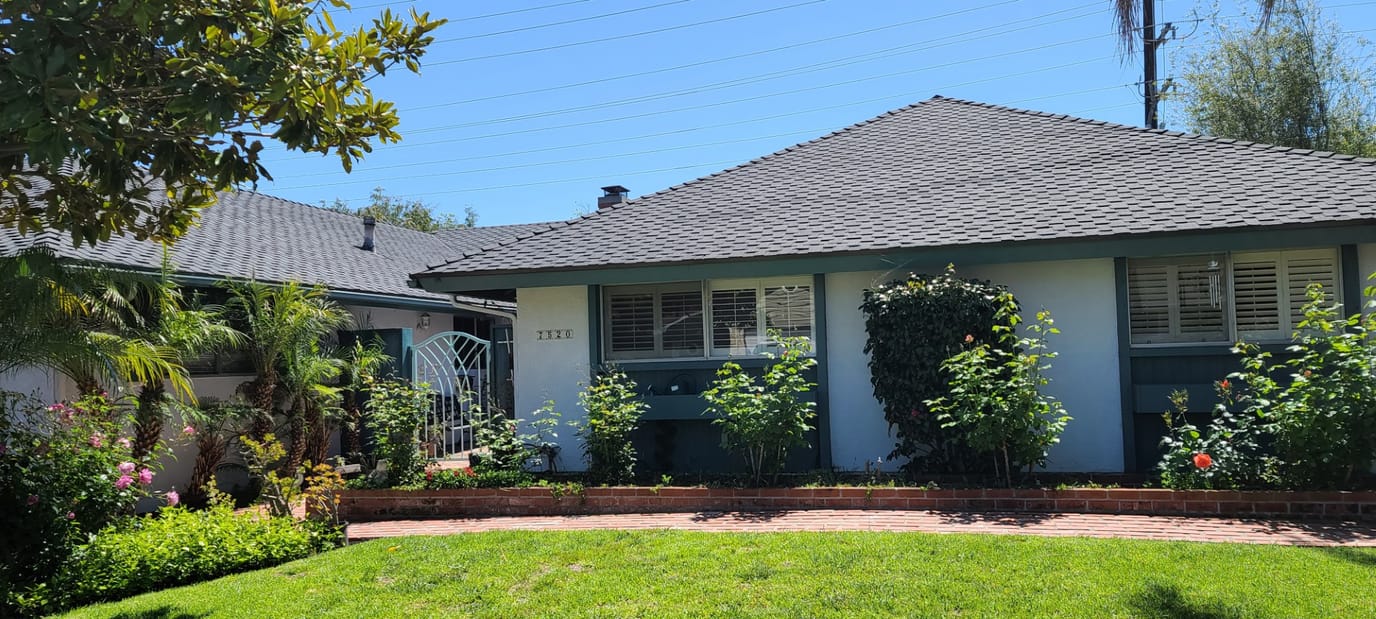 Exterior view of a residential building with lush landscaping